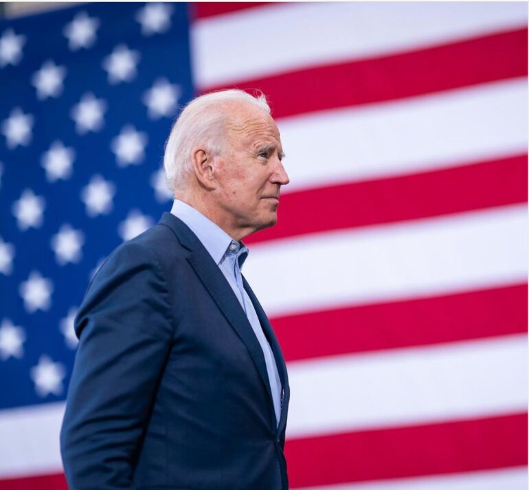 Joe Biden infront of flag
